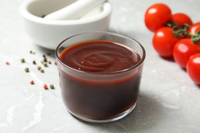 Glass bowl of hot barbecue sauce on table