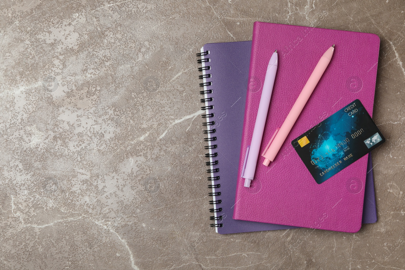 Photo of Credit card and stationery on marble table, flat lay. Space for text