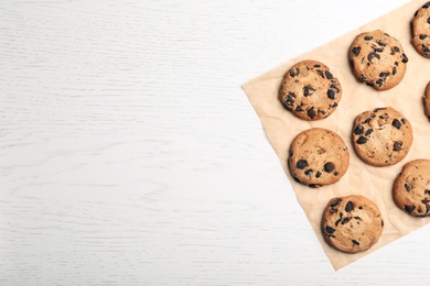 Flat lay composition with chocolate cookies and space for text on light background