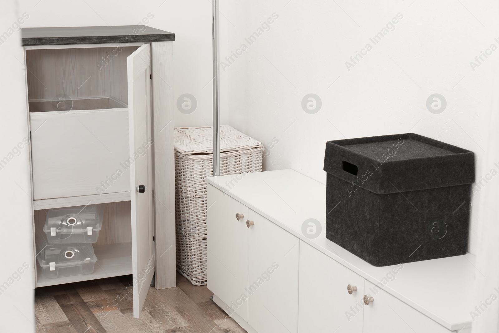 Photo of Dressing room with chest of drawers and wicker basket