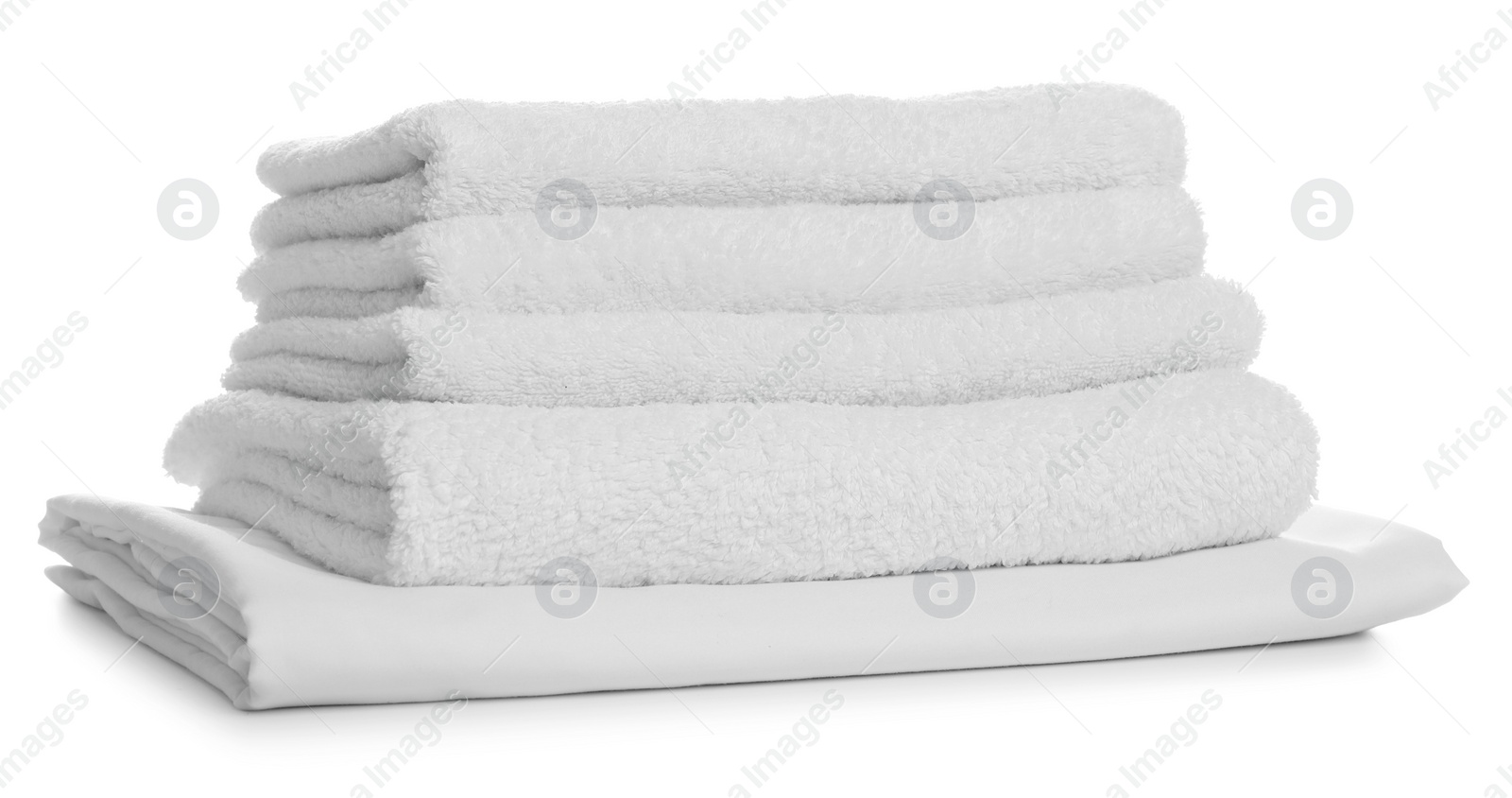 Photo of Stack of towels and bed sheet on white background