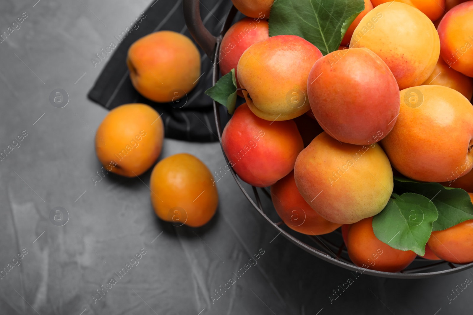 Photo of Delicious fresh ripe apricots on dark table, flat lay