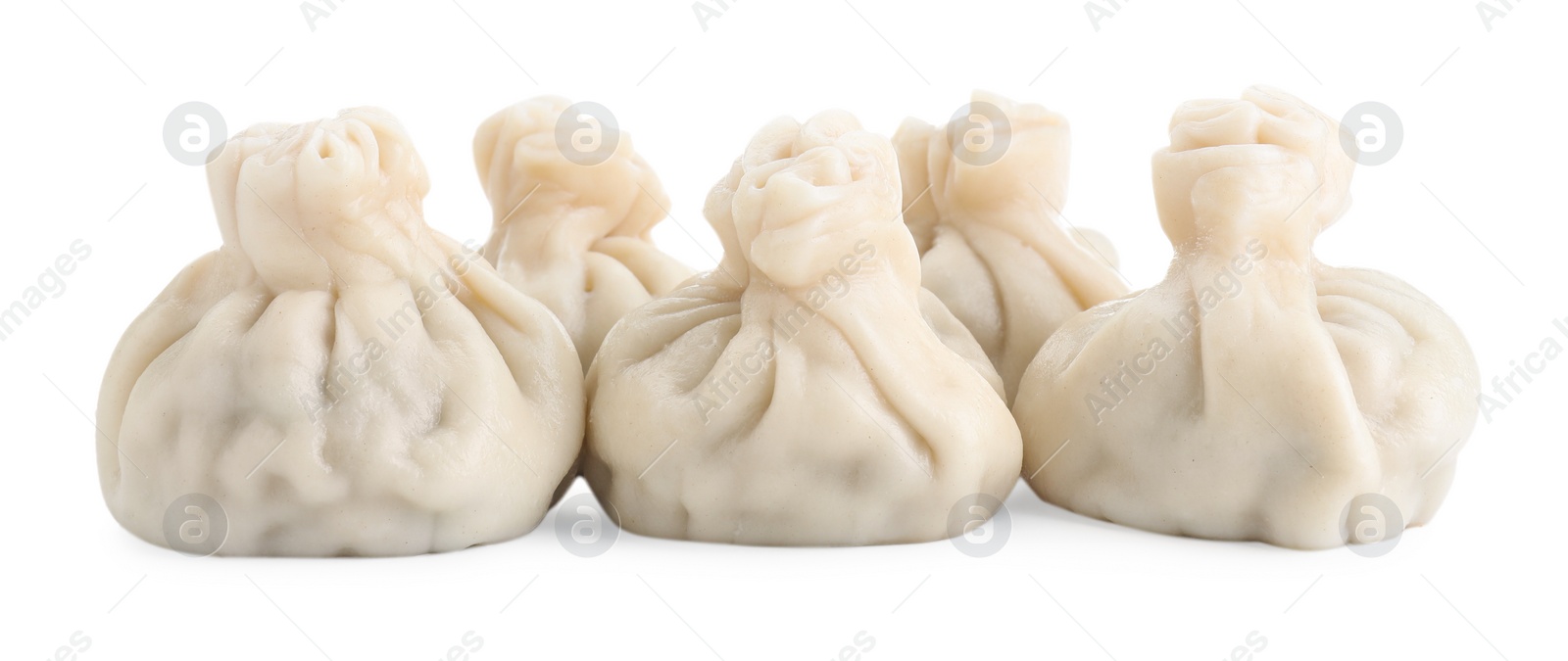 Photo of Many tasty khinkali (dumplings) isolated on white. Georgian cuisine