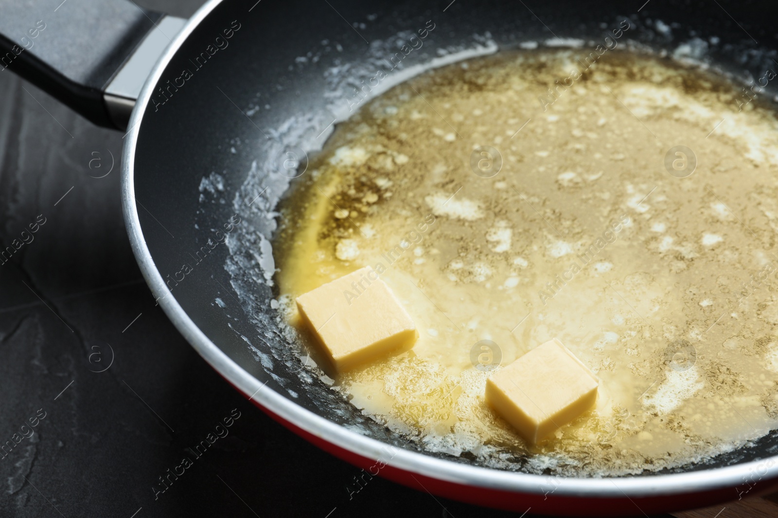 Photo of Melting butter in frying pan, closeup view