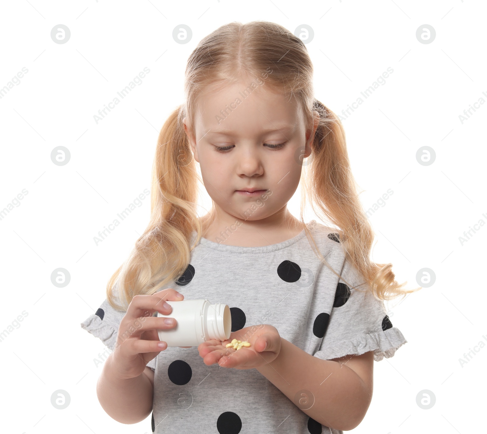 Photo of Little child with pills on white background. Danger of medicament intoxication