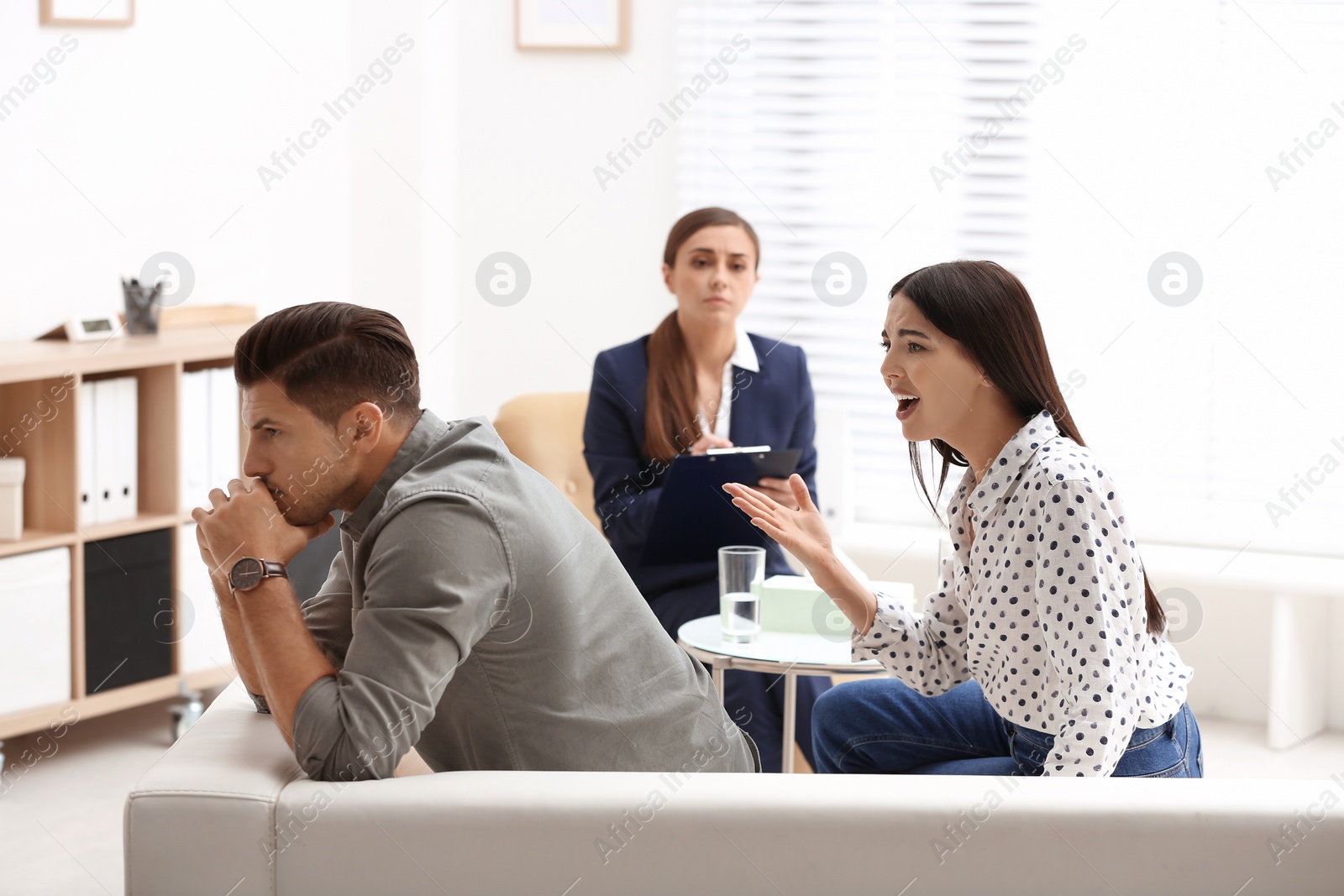 Photo of Professional psychologist working with couple in office