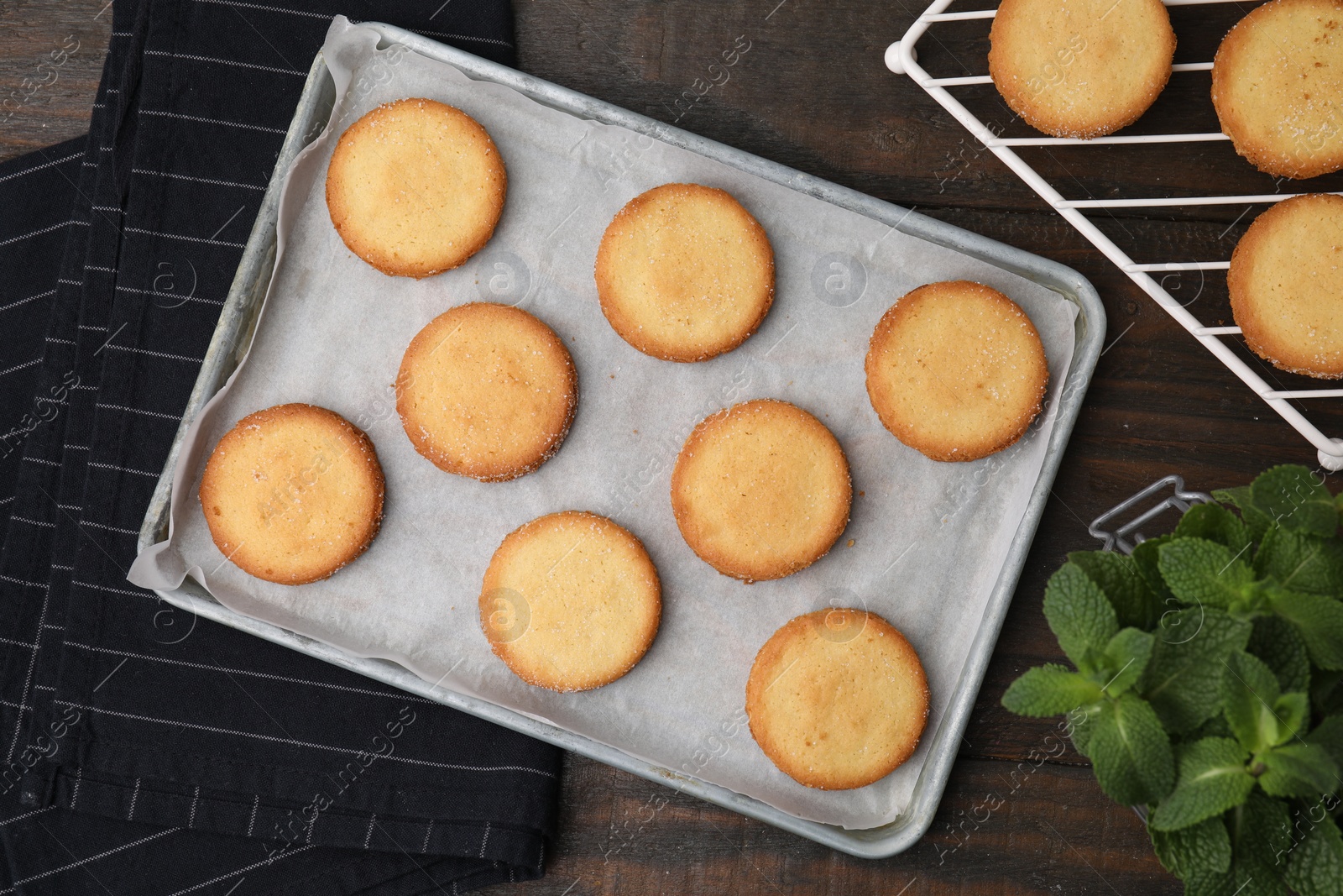 Photo of Tasty sweet sugar cookies and mint on wooden table, flat lay