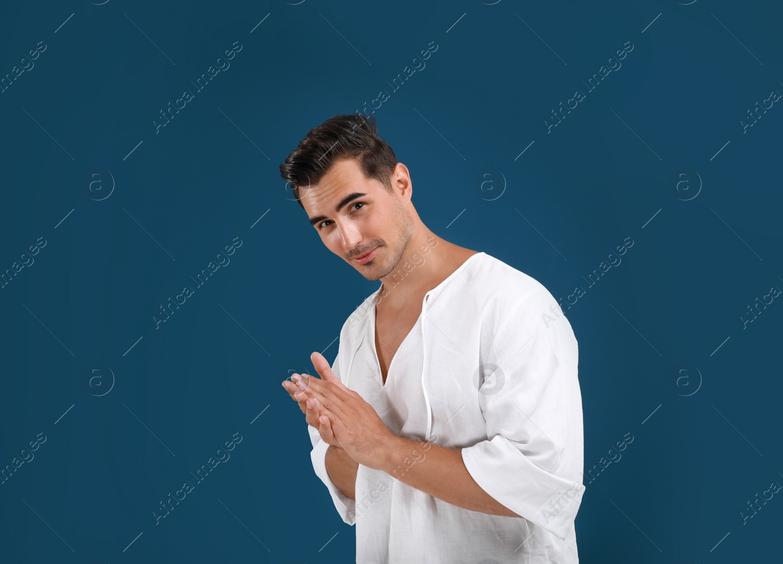 Photo of Portrait of handsome young man on blue background