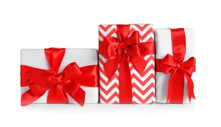 Photo of Beautifully wrapped gift boxes on white background