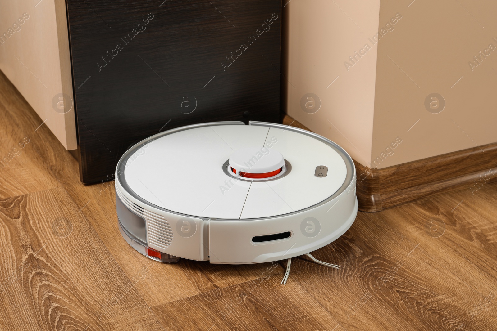 Photo of Robotic vacuum cleaner on wooden floor indoors