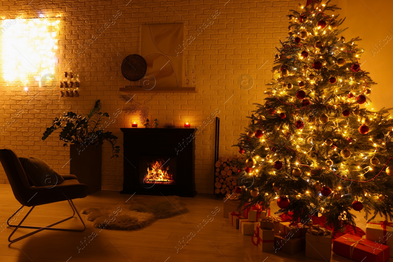 Photo of Beautiful Christmas tree with festive lights near fireplace in room. Interior design