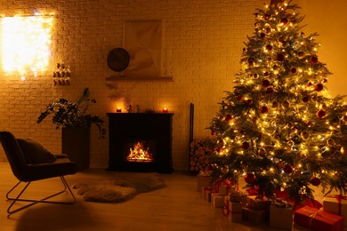 Photo of Beautiful Christmas tree with festive lights near fireplace in room. Interior design