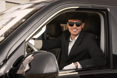 Photo of Professional driver in luxury car. Chauffeur service