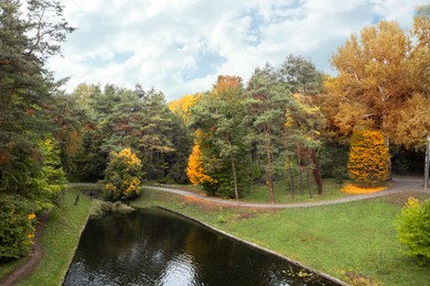 Image of Aerial view of beautiful autumn park with artificial pond