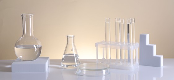 Photo of Laboratory analysis. Different glassware on table against beige background