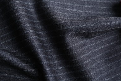 Photo of Texture of dark striped fabric as background, closeup