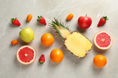 Flat lay composition with fresh fruits and strawberries on color background