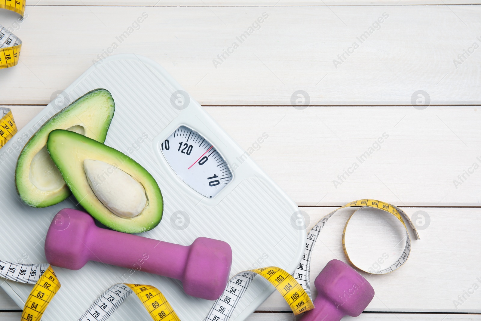 Flat lay composition with scales on white wooden table, space for text Photo of Flat lay composition with scales on white wooden table, space for text