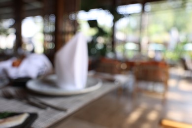 Photo of Blurred view of comfortable cafeteria with furniture