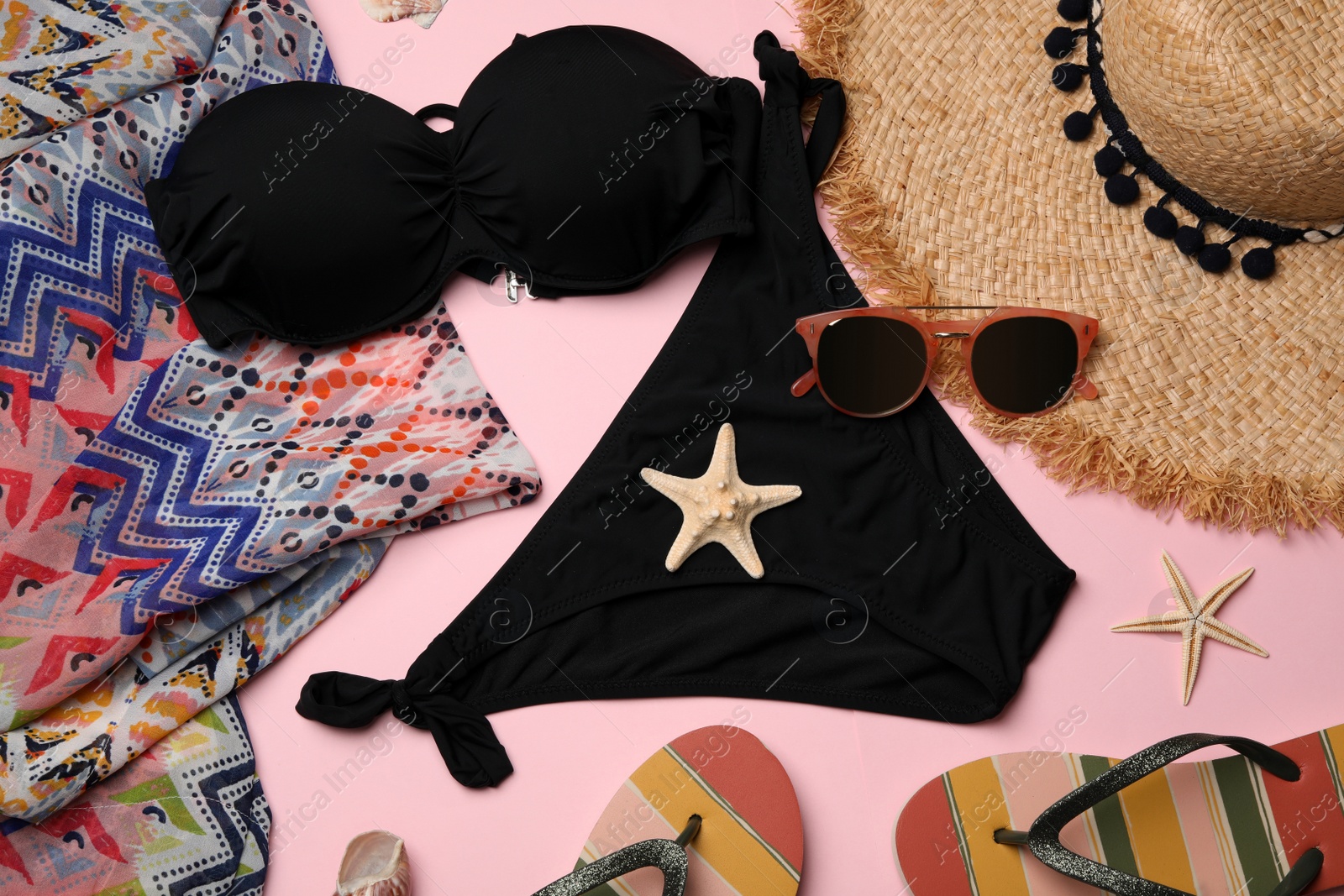 Photo of Flat lay composition with swimsuit and beach accessories on color background