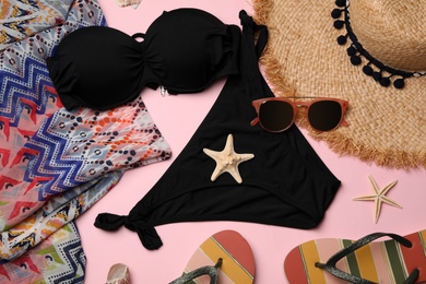 Flat lay composition with swimsuit and beach accessories on color background