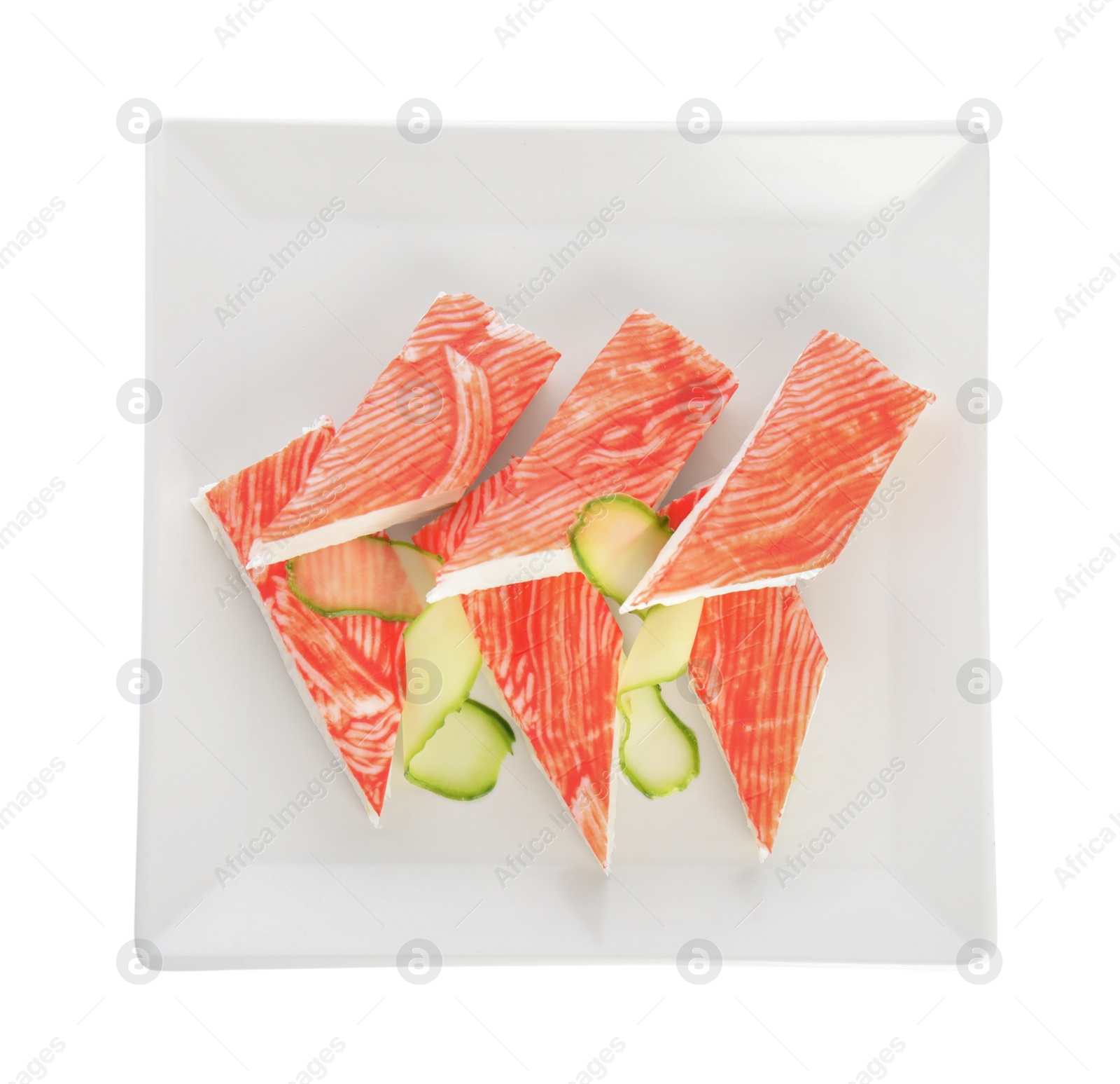 Photo of Fresh crab sticks with cucumber isolated on white, top view
