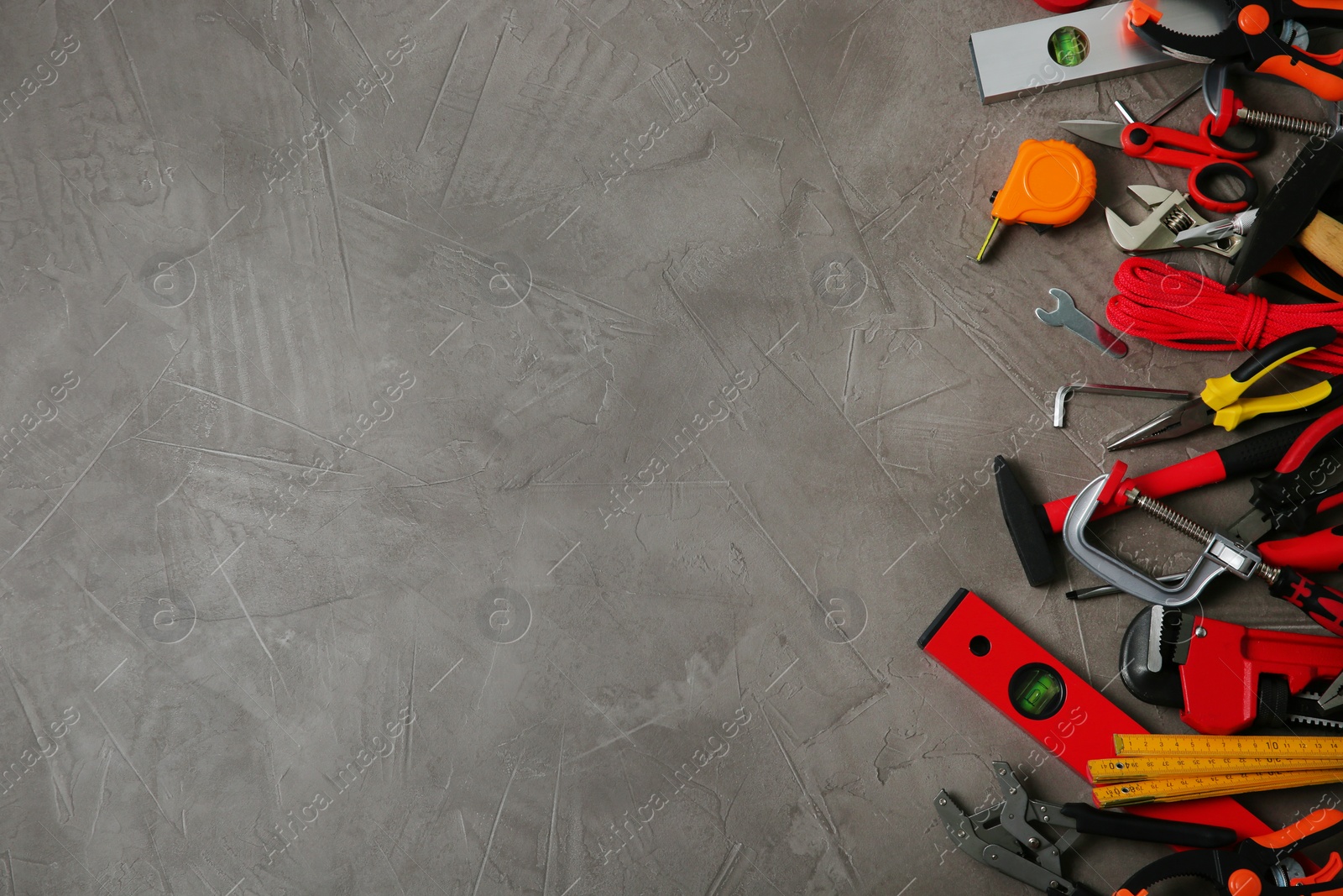 Photo of Flat lay composition with repair tools on grey stone table, space for text