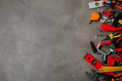 Photo of Flat lay composition with repair tools on grey stone table, space for text