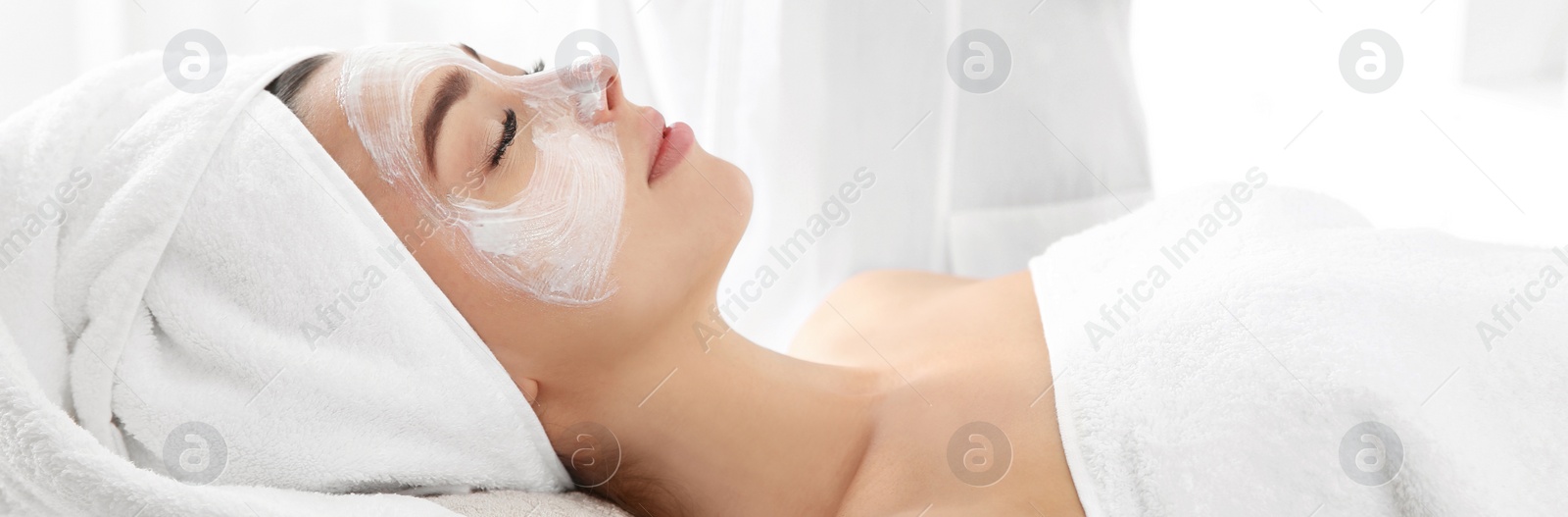 Image of Pretty woman with mask on her face in spa salon. Banner design