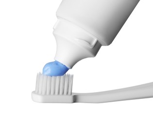 Photo of Applying paste on toothbrush against white background, closeup