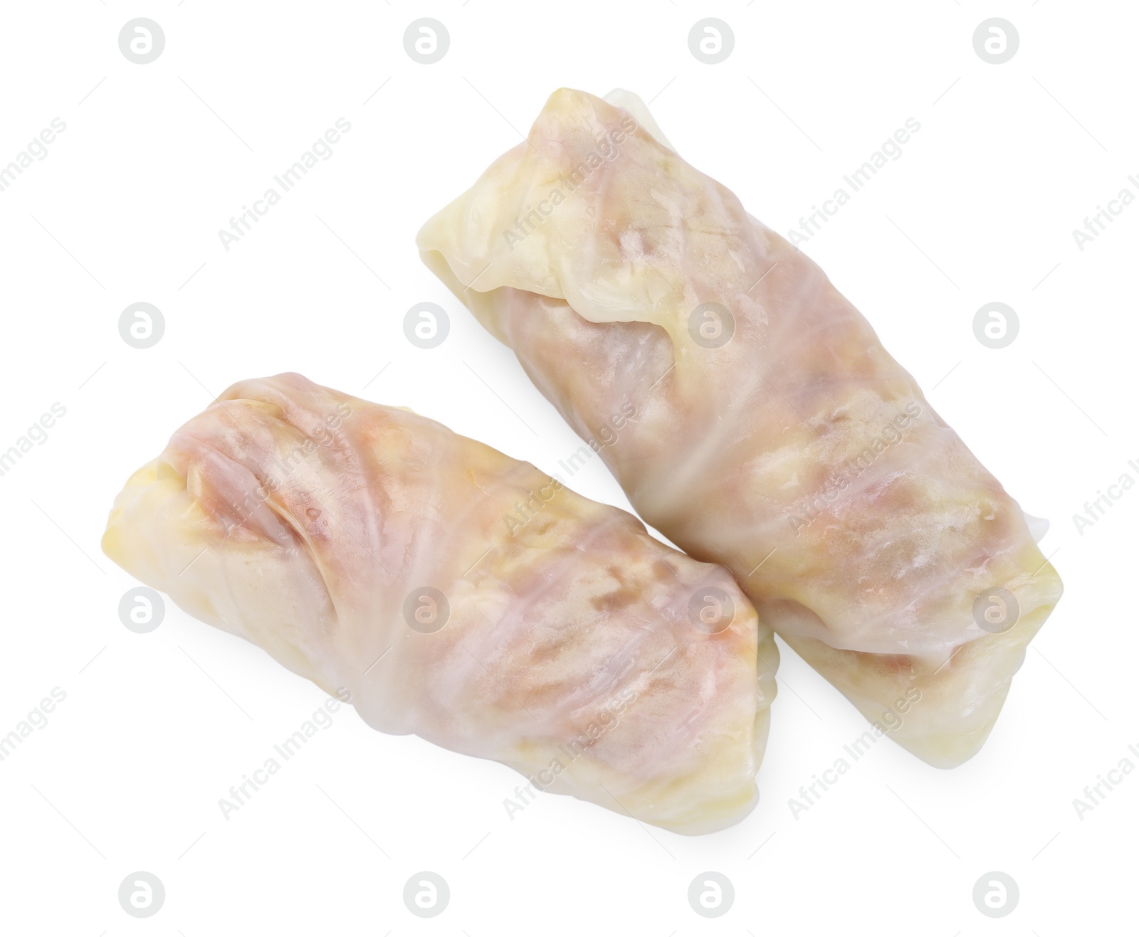 Photo of Uncooked stuffed cabbage rolls isolated on white, top view