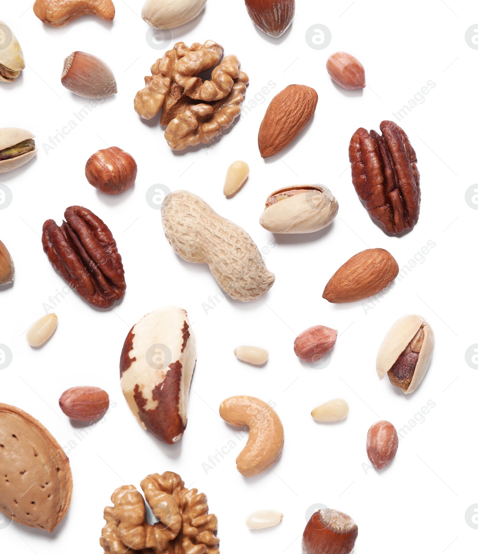 Photo of Different delicious nuts on white background, flat lay. Space for text