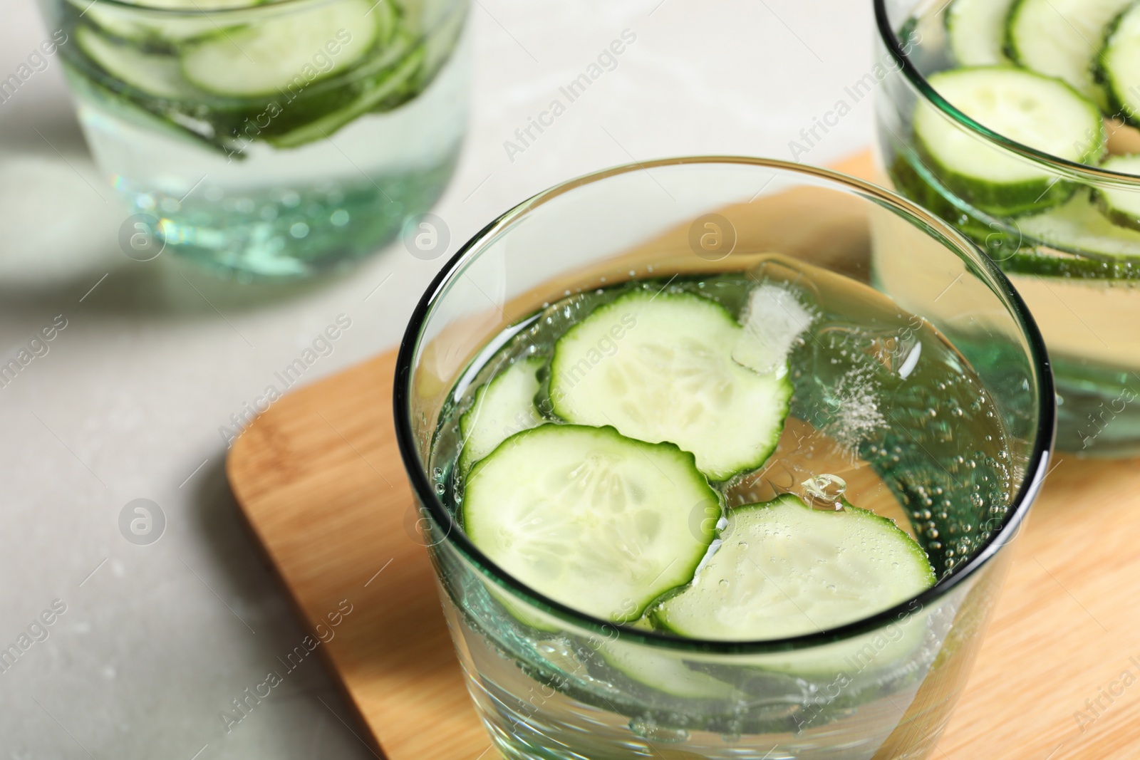 Photo of Glasses of fresh cucumber water on table, closeup