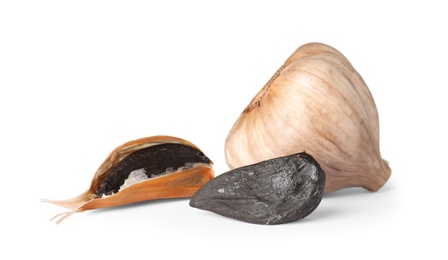 Photo of Aged black garlic on white background. Asian cuisine