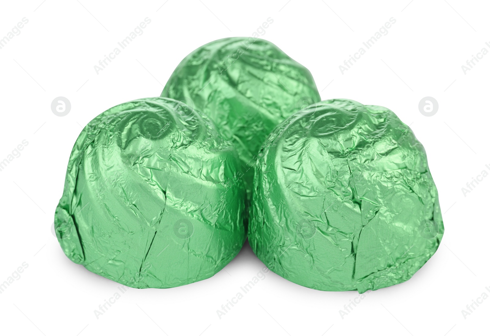 Photo of Candies in light green wrappers isolated on white