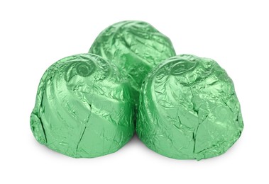 Photo of Candies in light green wrappers isolated on white
