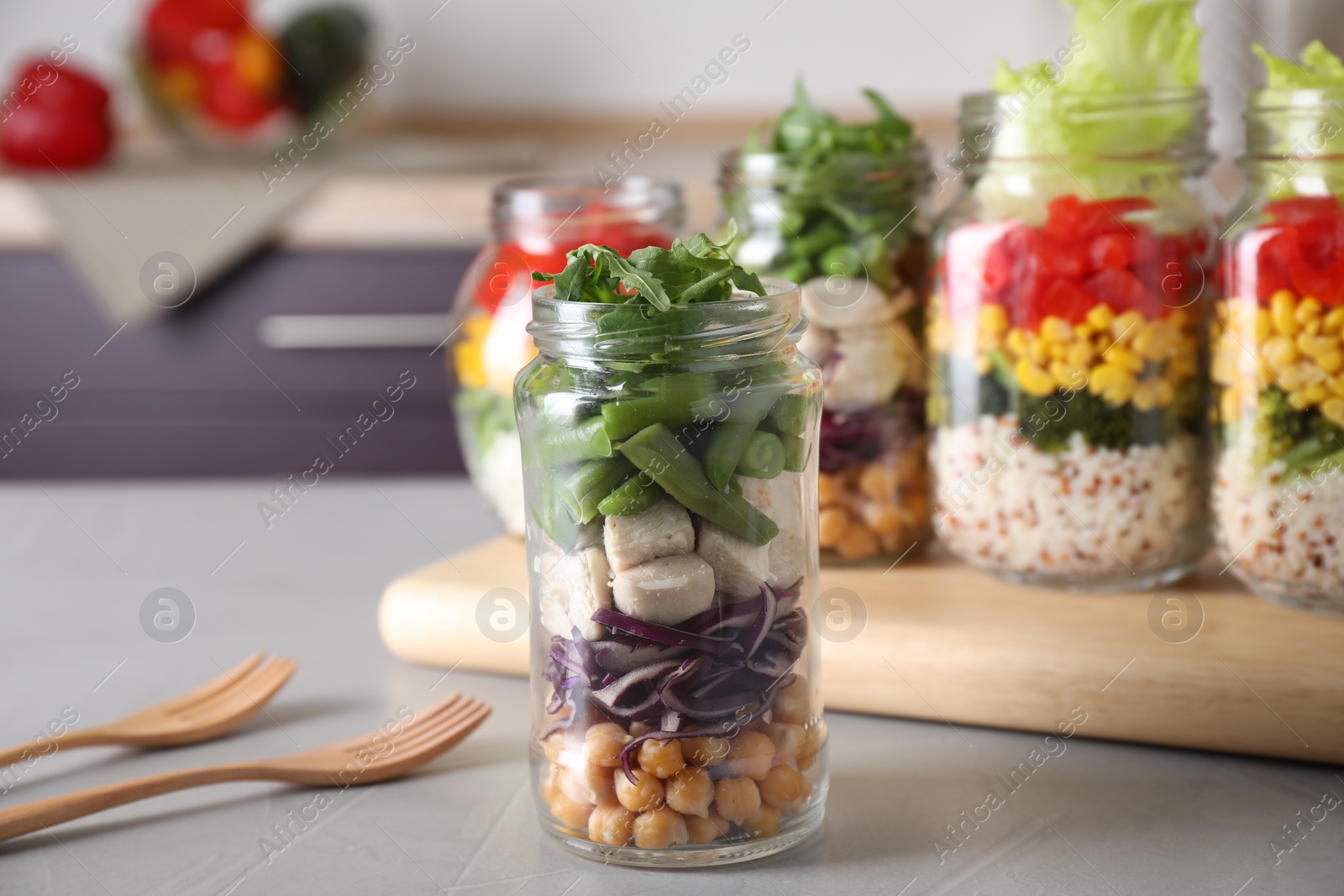 Photo of Glass jar with healthy meal on light grey table