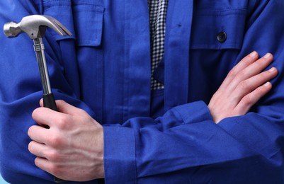 Photo of Professional repairman holding hammer, closeup. Industrial tool
