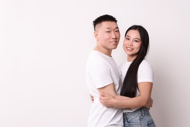 Portrait of happy couple on white background, space for text