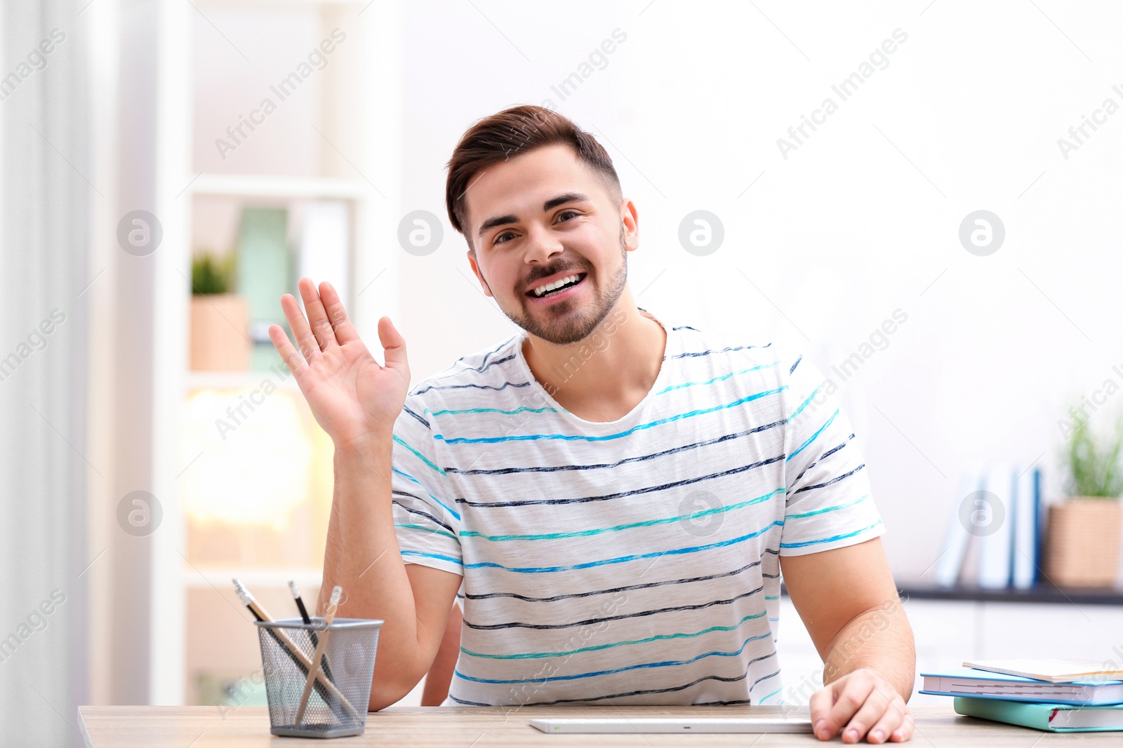 Photo of Handsome man using video chat for conversation indoors