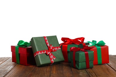 Photo of Different Christmas gifts on wooden table against white background