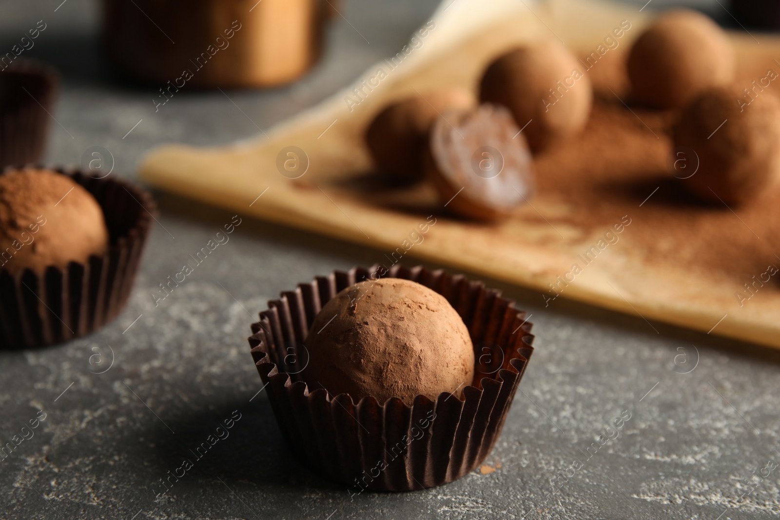 Photo of Tasty chocolate truffles on grey background, closeup