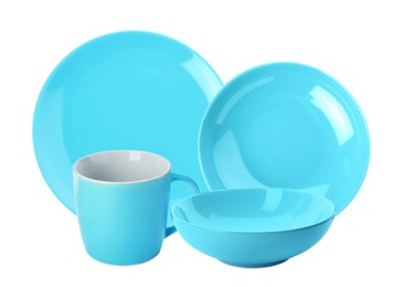 Set of beautiful turquoise dinnerware on white background