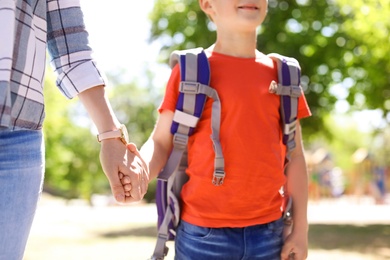 Young woman taking her child to school