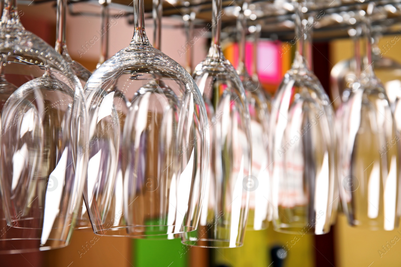 Photo of Clean glasses hanging over counter in bar