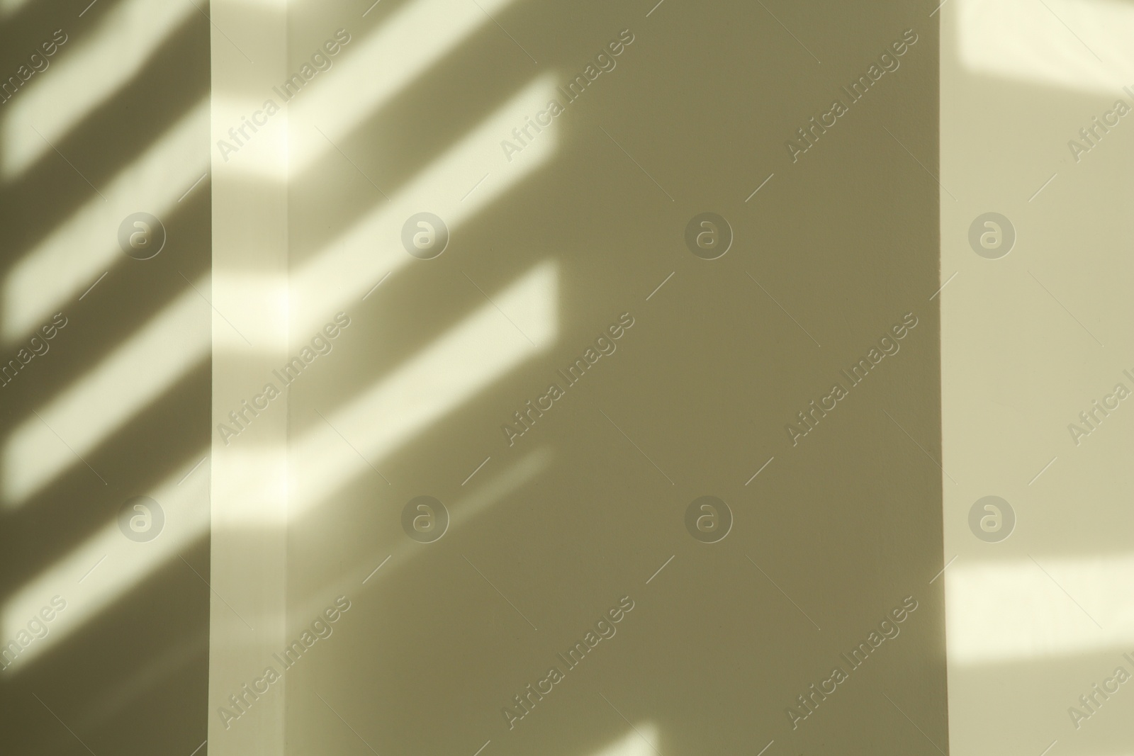 Photo of Lines made of light and shadows on white wall