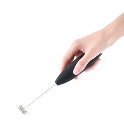 Photo of Woman holding black milk frother wand on white background, closeup