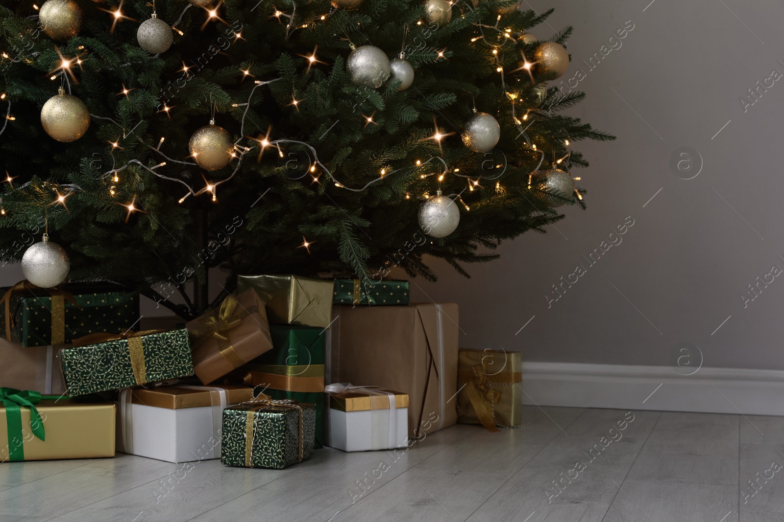 Photo of Beautifully decorated Christmas tree and gifts indoors