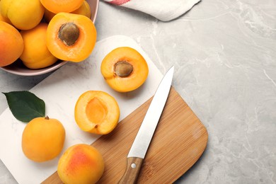 Delicious fresh ripe apricots on grey marble table, flat lay. Space for text