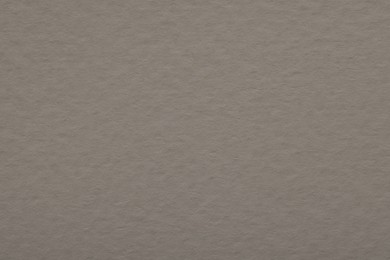 Photo of Texture of light grey paper sheet as background, top view